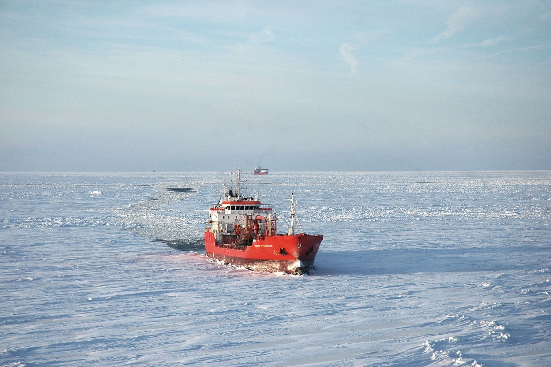 A cargo ship breaking through sea ice